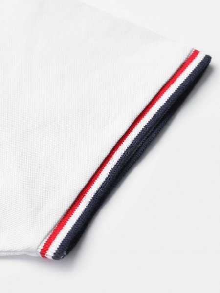 Liserés tricolores bleu blanc rouge en bord de manches sur le polo Prestige Women en coloris blanc