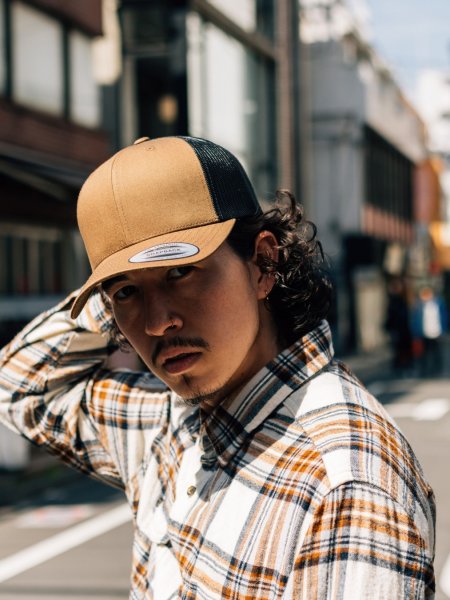Casquette trucker rétro bicolore portée par un homme Casquette trucker rétro bicolore portée par un homme